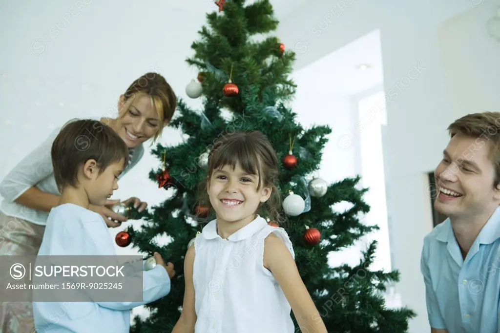 Family decorating Christmas tree