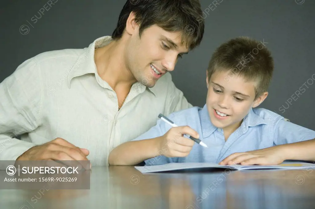 Man helping boy with homework