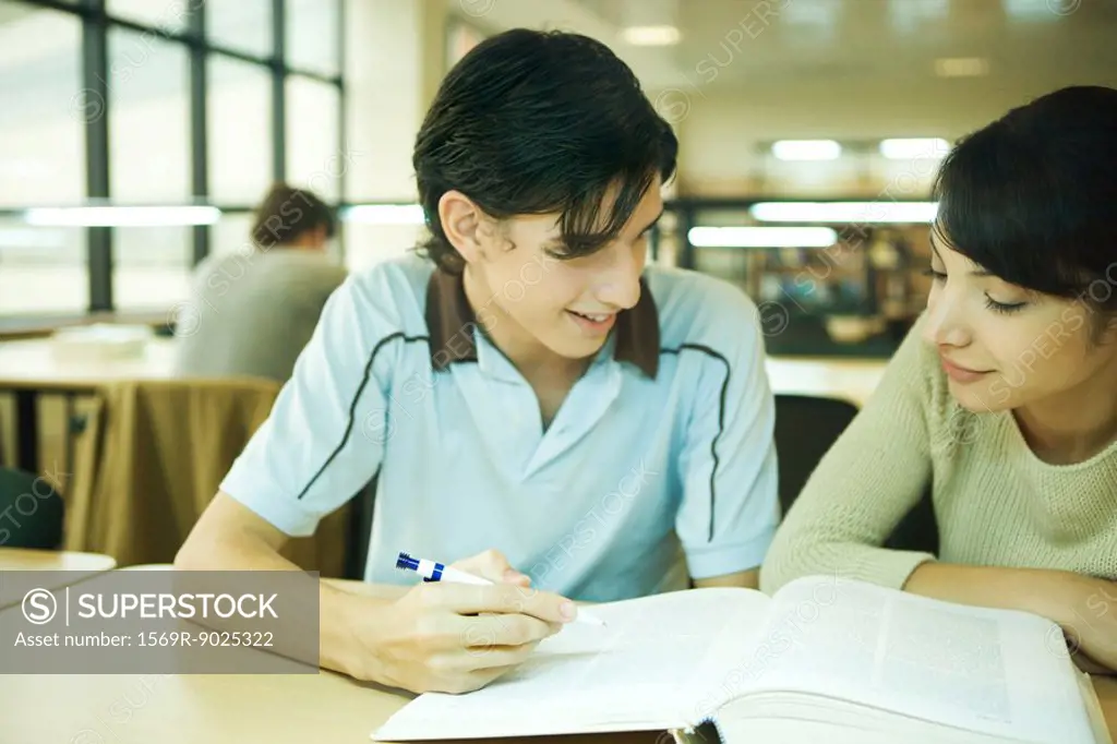 Students studying together in university library