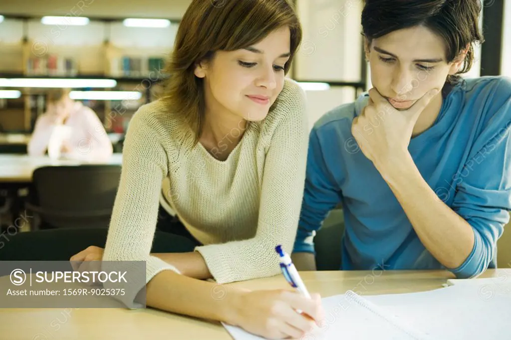 Students studying together in university library