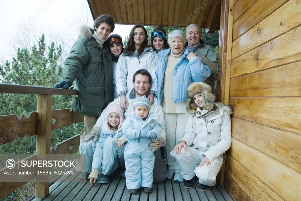 Mixed age group standing on deck in winter clothes, group portrait, full length