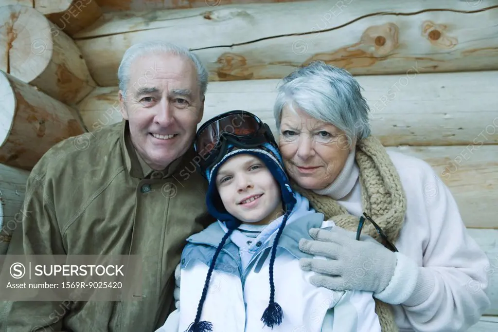 Boy with grandparents, wearing winter clothes, portrait