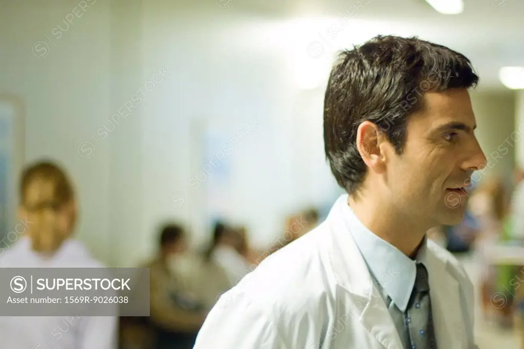 Doctor, hospital waiting room in background