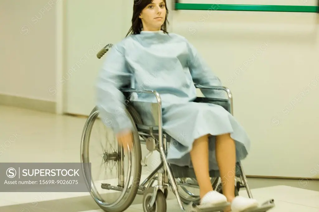 Female patient using wheelchair, blurred motion
