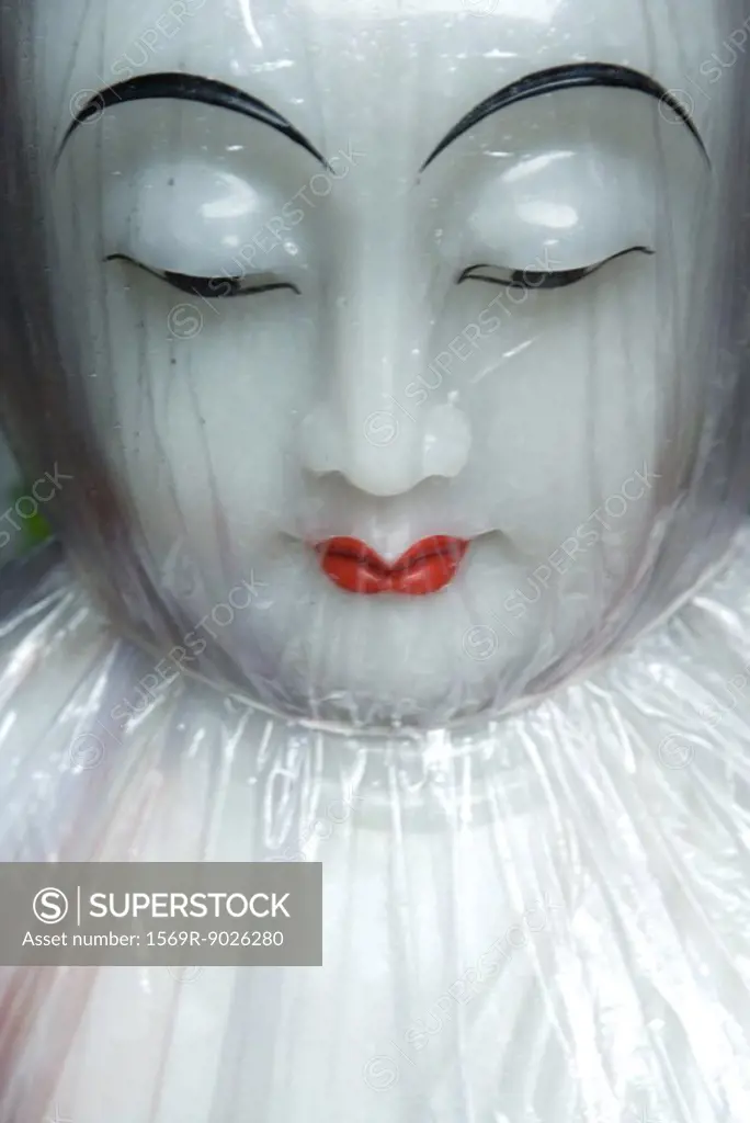 Doll face under cellophane