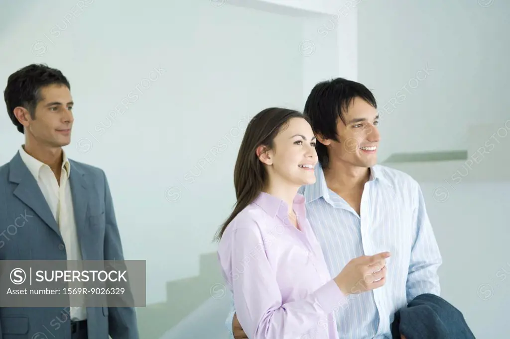 Real estate agent showing home to young couple