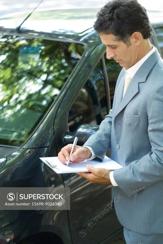 Insurance adjuster inspecting car