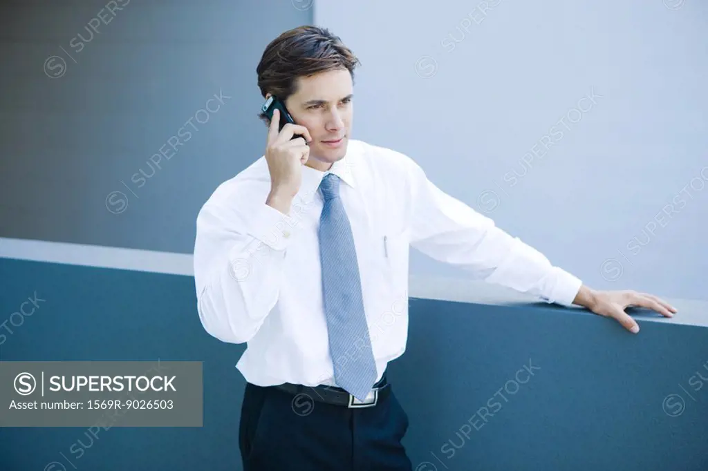 Businessman using cell phone, waist up