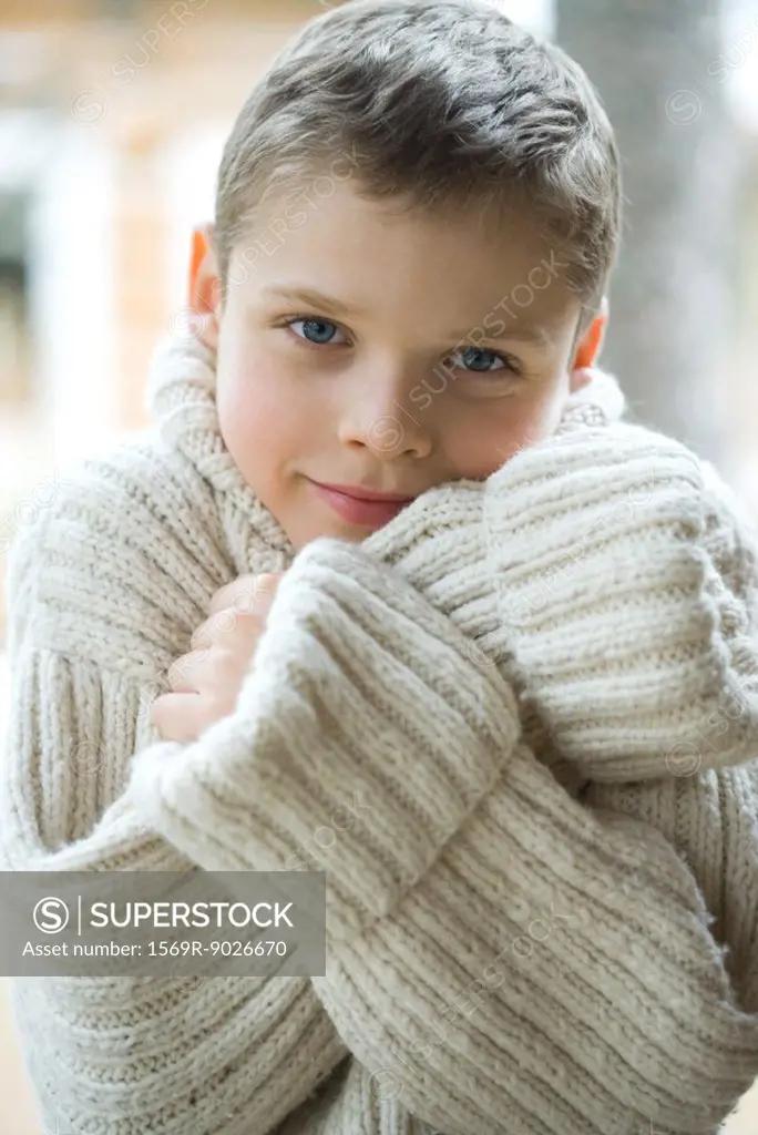 Boy wearing thick wool sweater, portrait