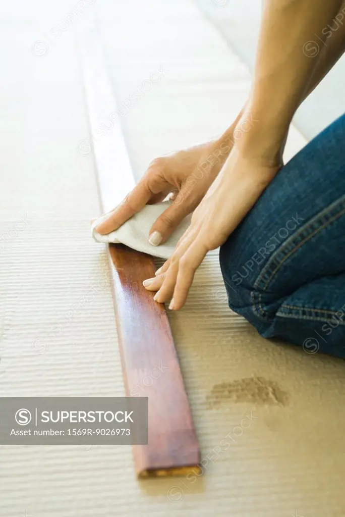 Woman preparing wood plank, cropped view