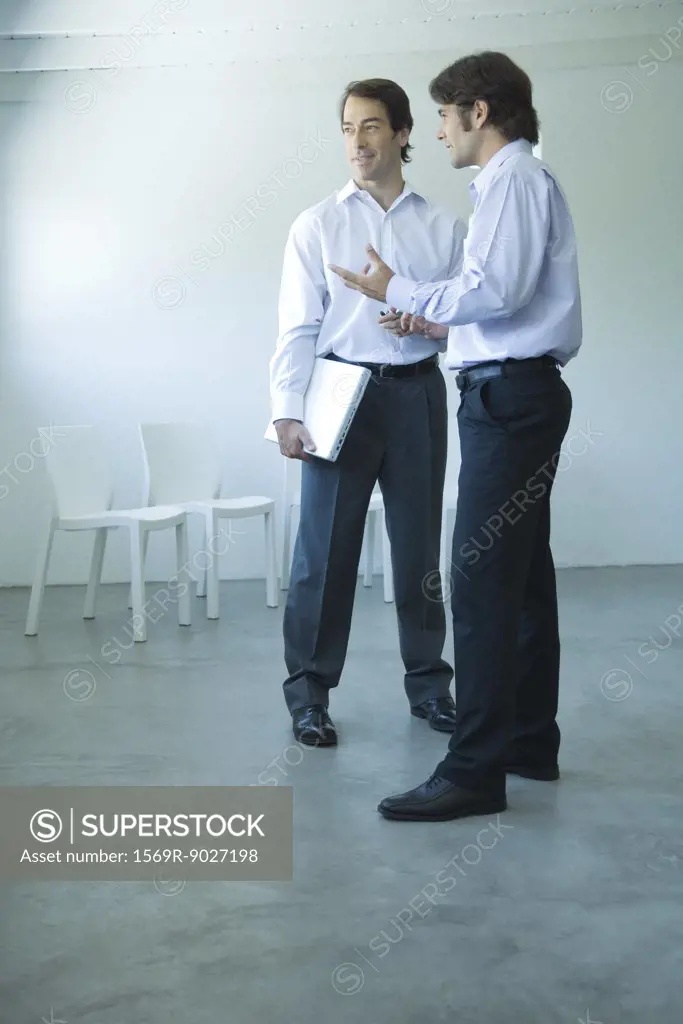 Two businessmen having discussion, full length view