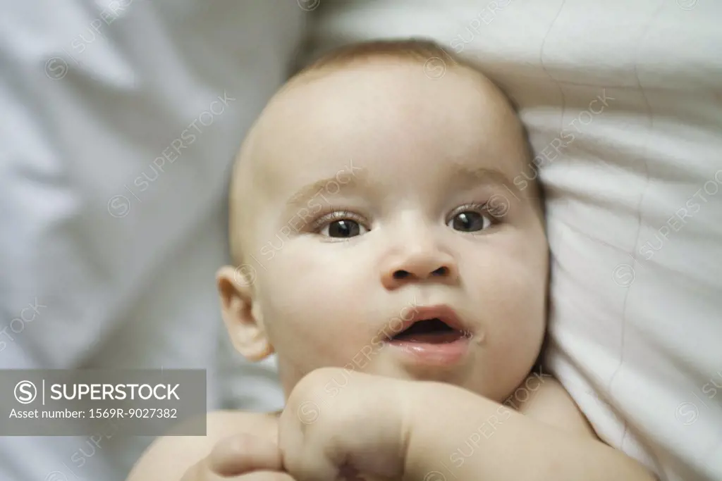 Baby in bed, head and shoulders, close-up