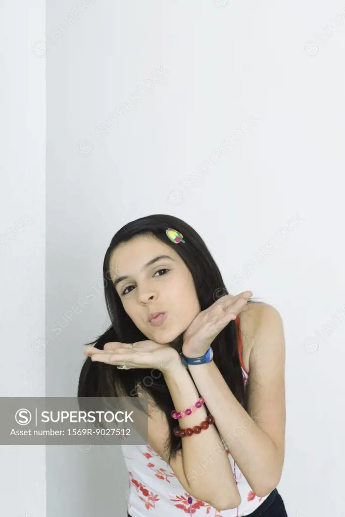 Teenage blowing a kiss at camera, portrait