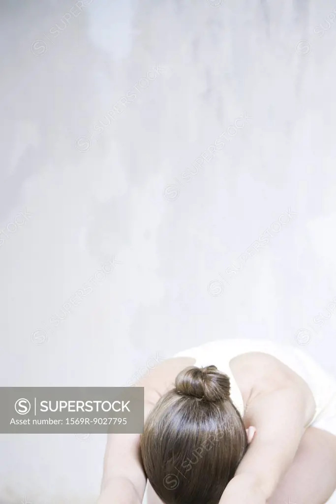 Woman bending over, head down, cropped view