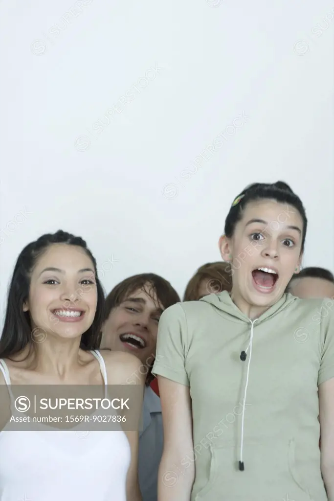 Group of young friends jumping for joy, portrait