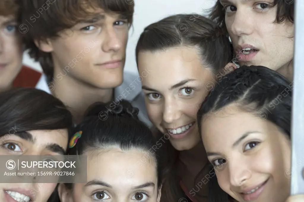 Group of young friends posing for photo, looking at camera, cropped, portrait