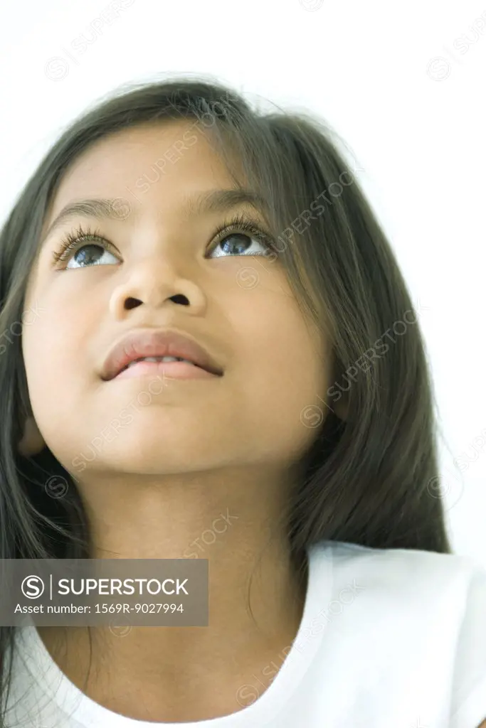 Girl looking up, smiling, portrait