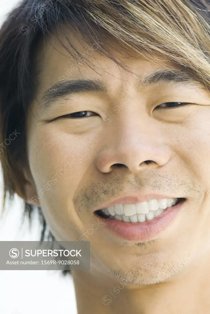Man smiling at camera, cropped portrait