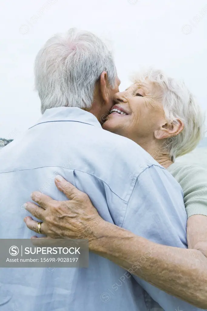 Senior couple hugging, close-up