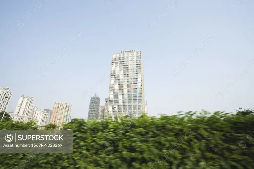 China, Guangdong Province, Guangzhou, high rises and hedge