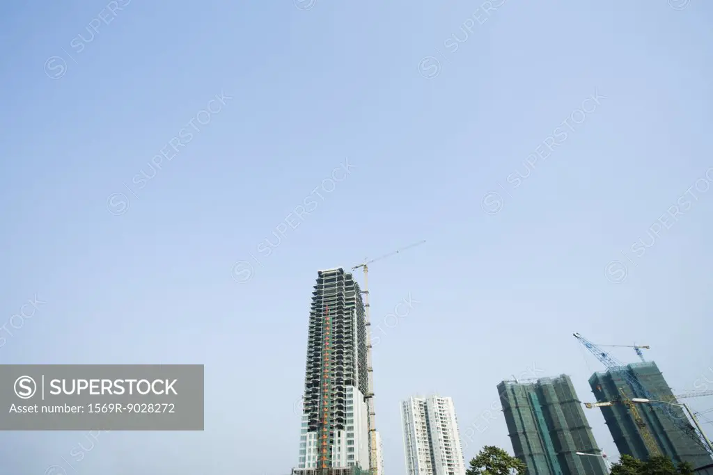 China, Guangdong Province, Guangzhou, high rises and cranes