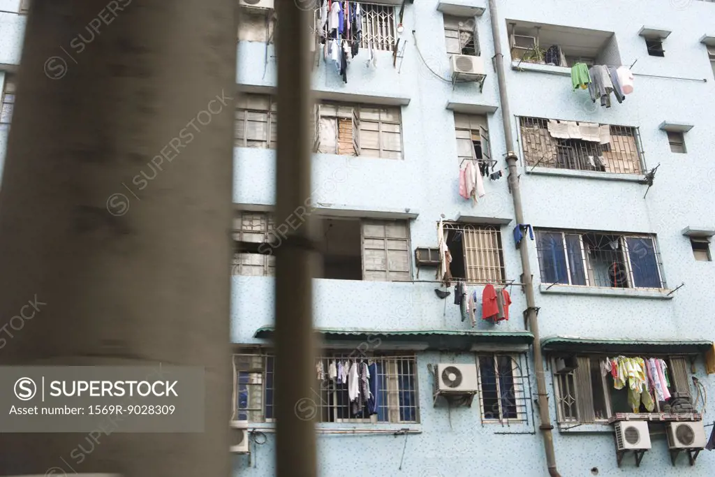 Apartment building with laundry hanging in front of windows
