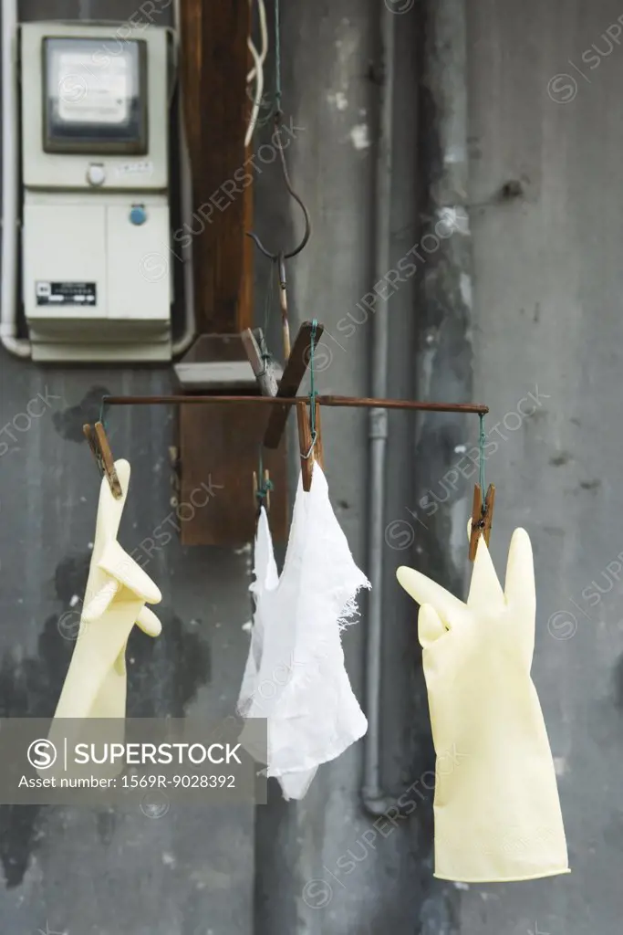 Plastic gloves and rag hanging to dry