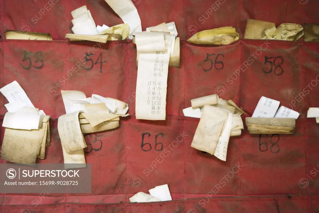 Fortune slips in Chinese temple, close-up