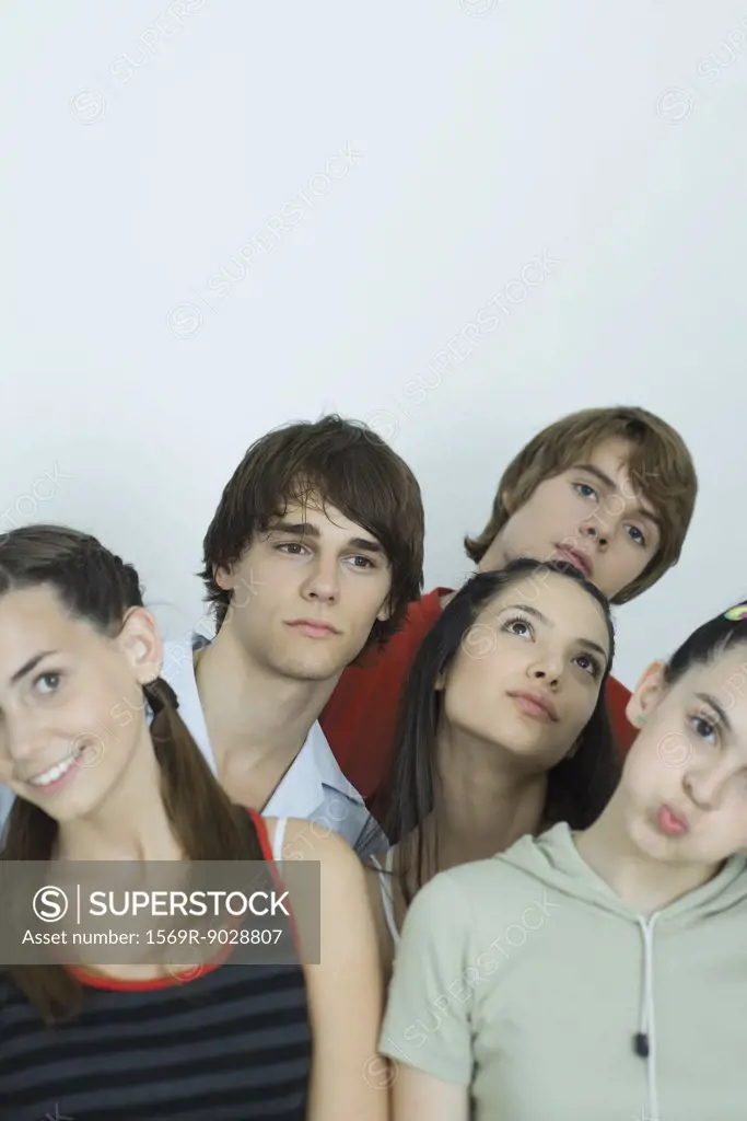 Group of young friends posing for photo, heads tilted, portrait