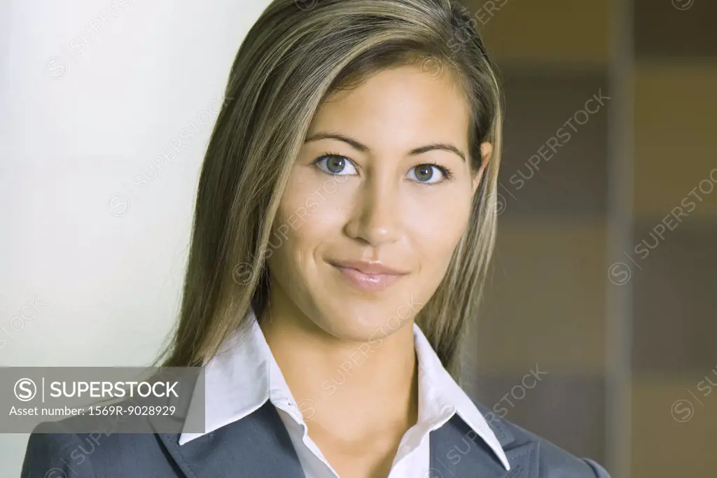Young businesswoman smiling at camera, portrait