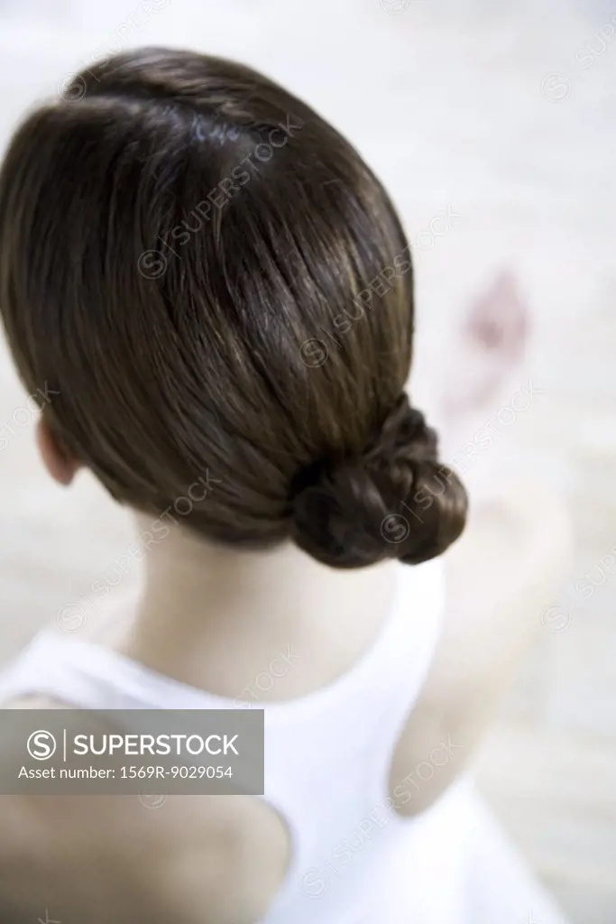Brunette woman wearing hair in chignon, rear view