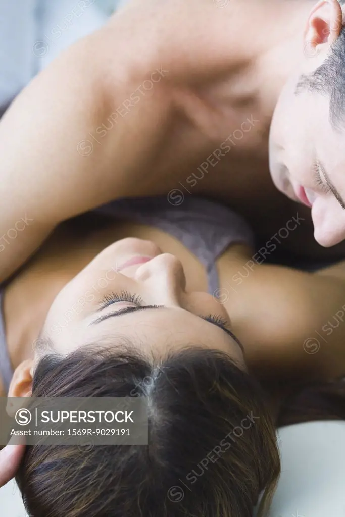 Man lying on top of woman, cropped view