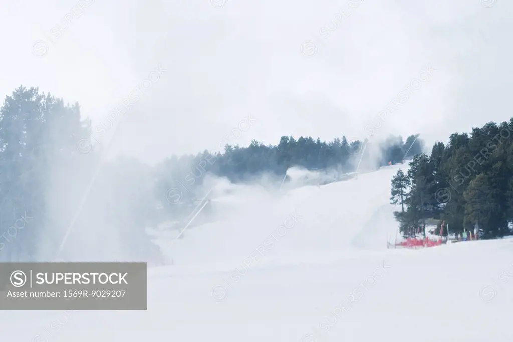 Ski slopes, artificial snow being sprayed