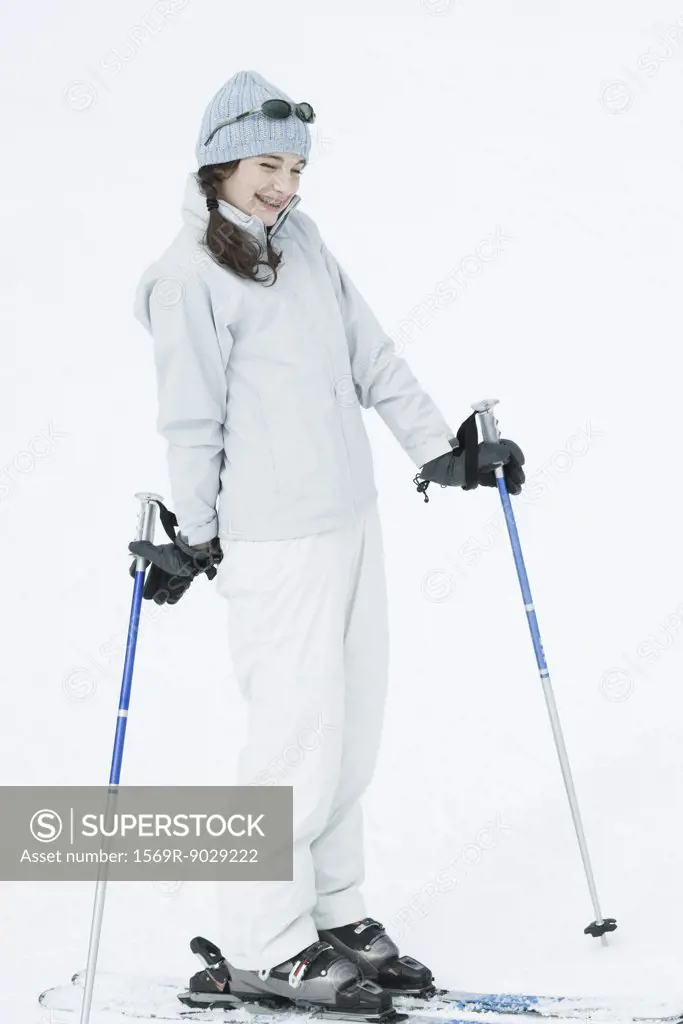 Teen girl wearing skis, smiling