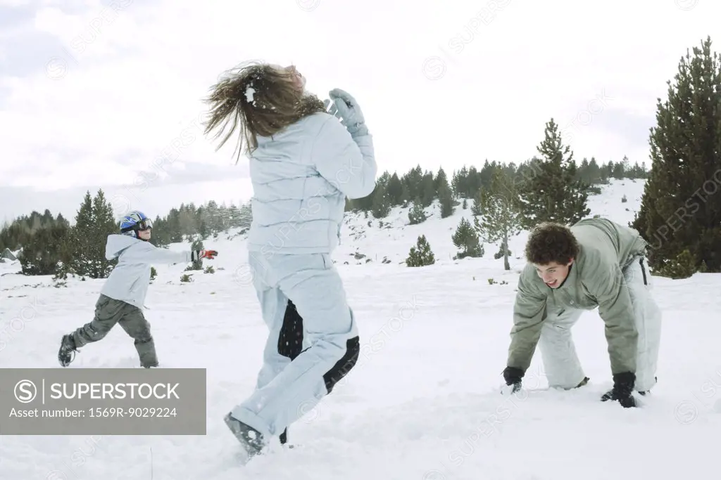 Young friends having snowball fight, action shot