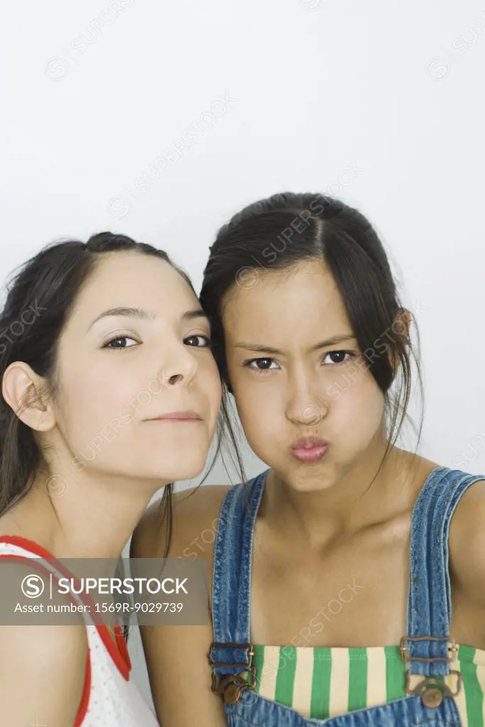 Two young friends making faces at camera