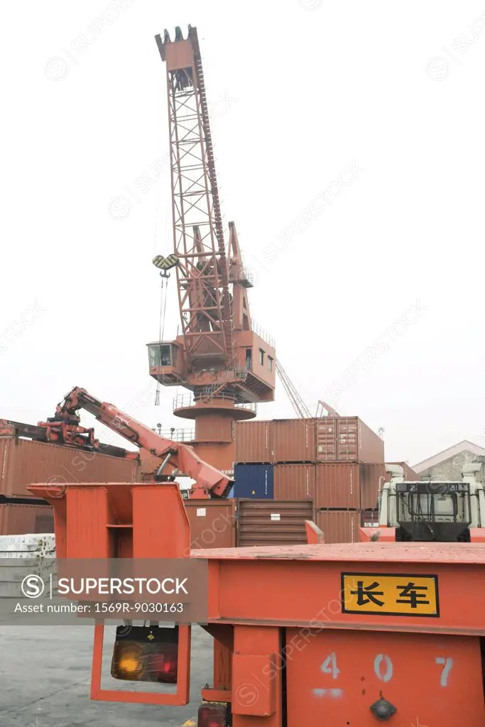 Cranes and cargo containers in shipyard
