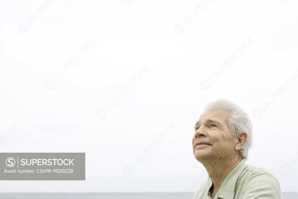 Senior man, ocean horizon in background