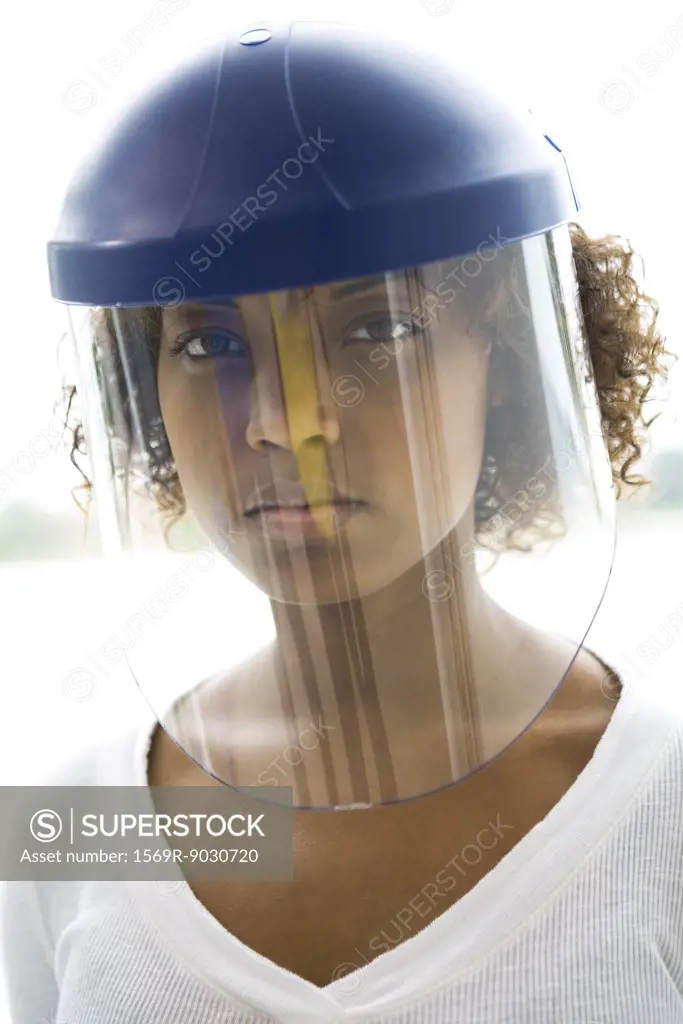 Woman wearing protective helmet, looking at camera