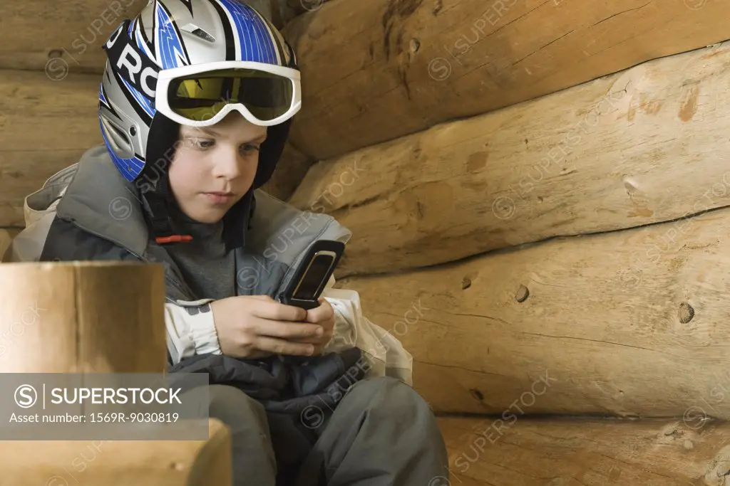 Boy in ski gear using cell phone