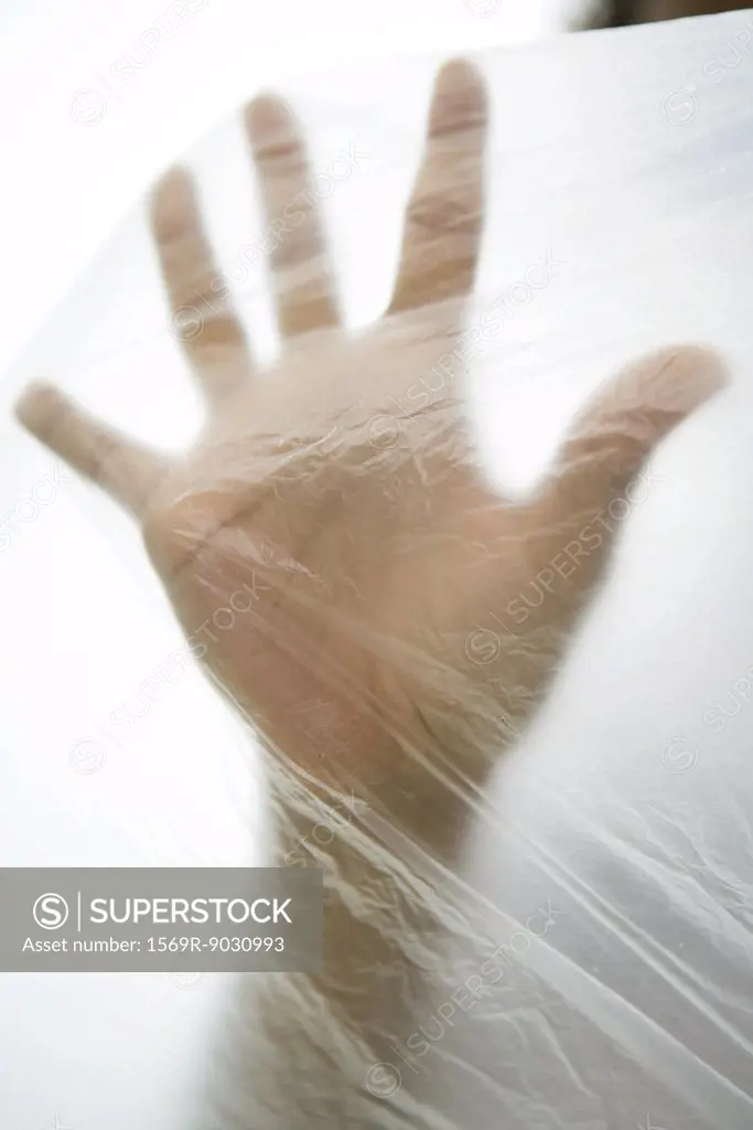 Hand inside plastic bag, cropped view