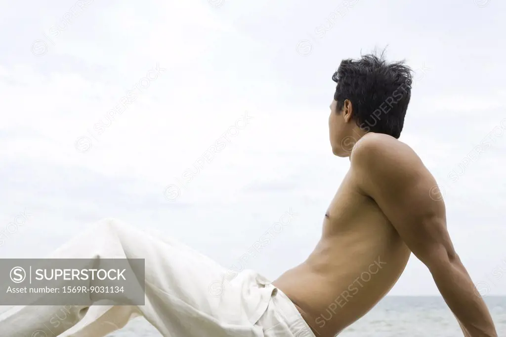 Man sitting and looking at view, side view