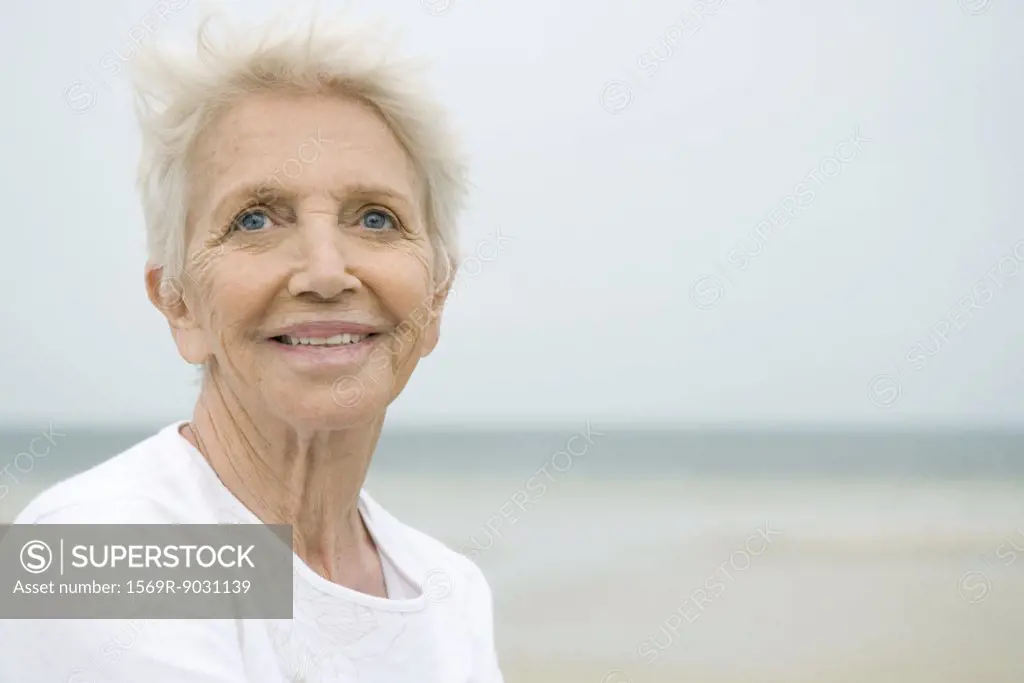 Senior woman smiling, looking away, portrait
