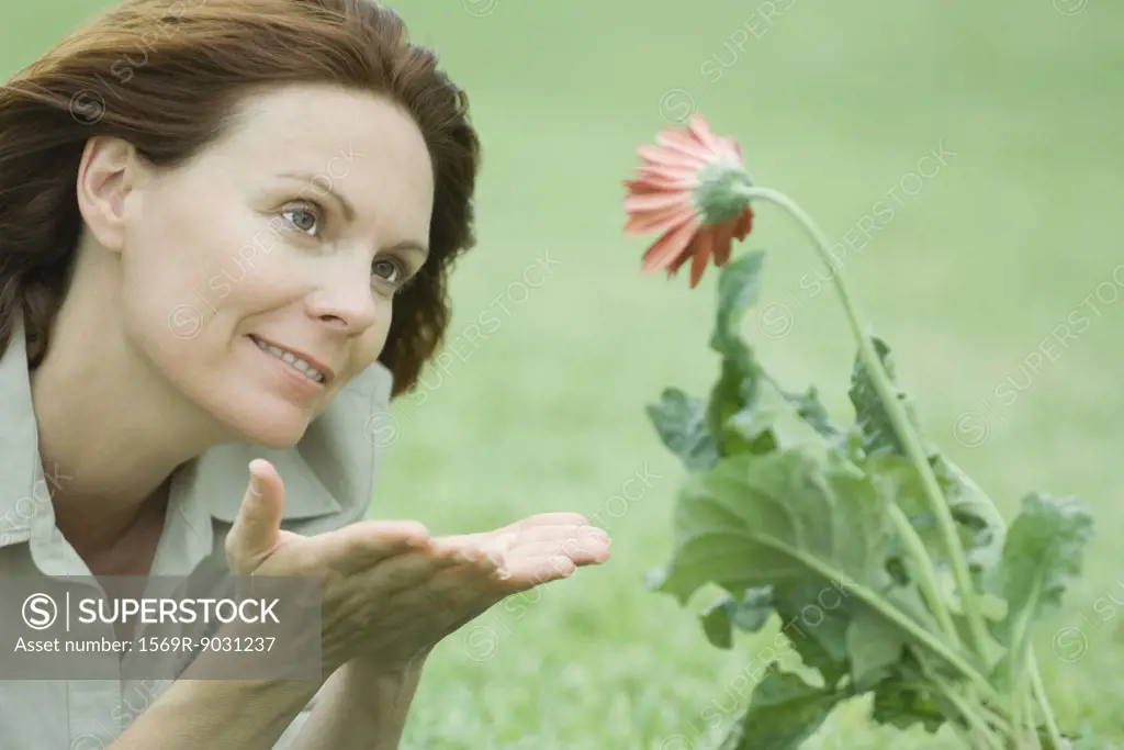 Woman beholding flower