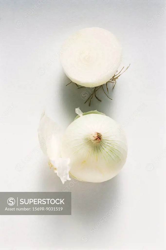 White onions, one cut in half, close-up