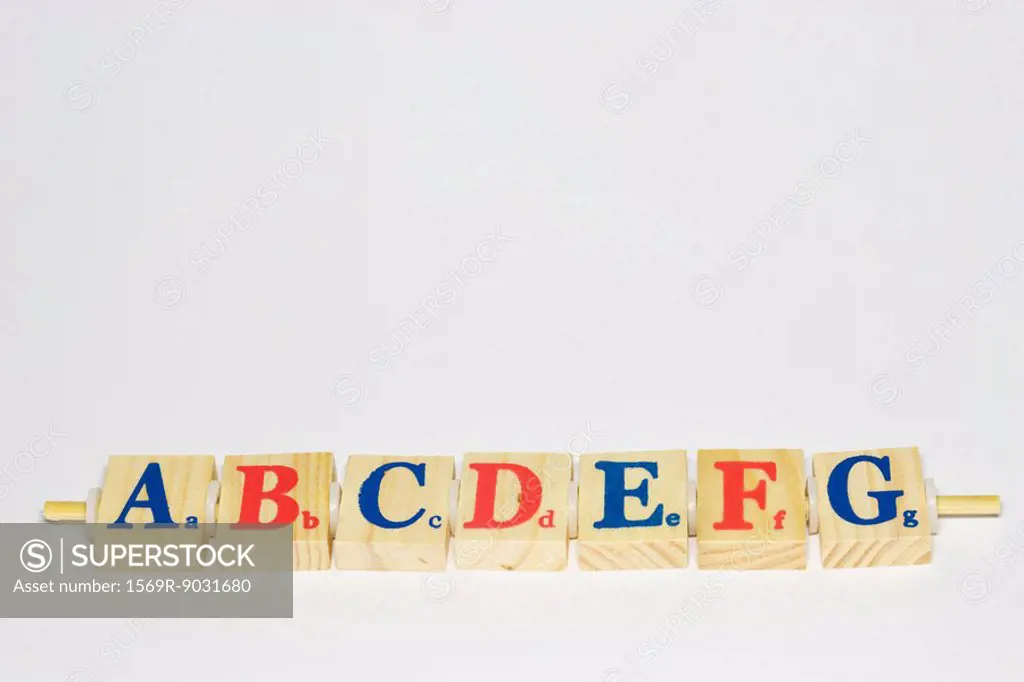 Wooden alphabet blocks in a row, close-up