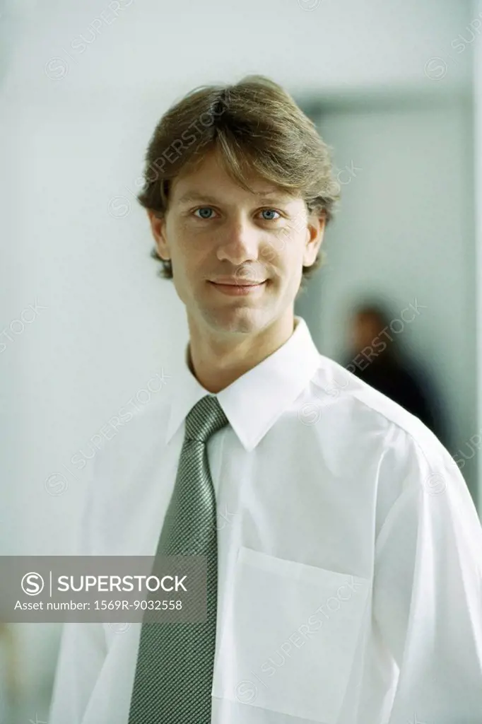 Businessman smiling at camera, portrait
