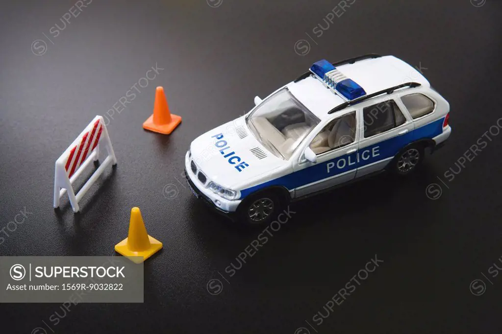 Toy police car and traffic cones, close-up