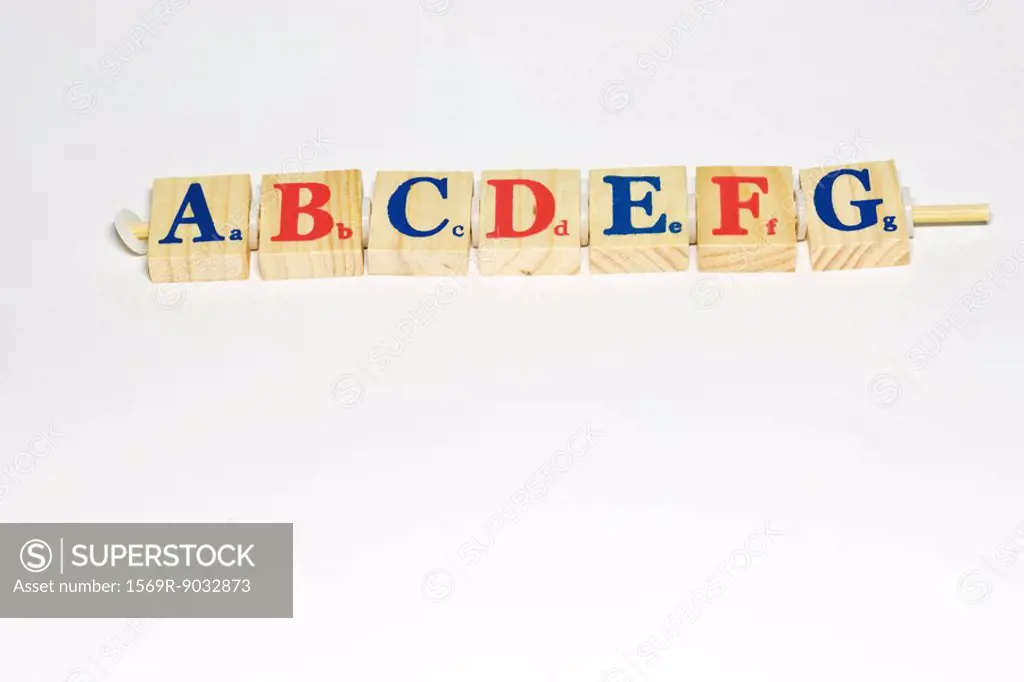 Wooden alphabet blocks lined up, close-up
