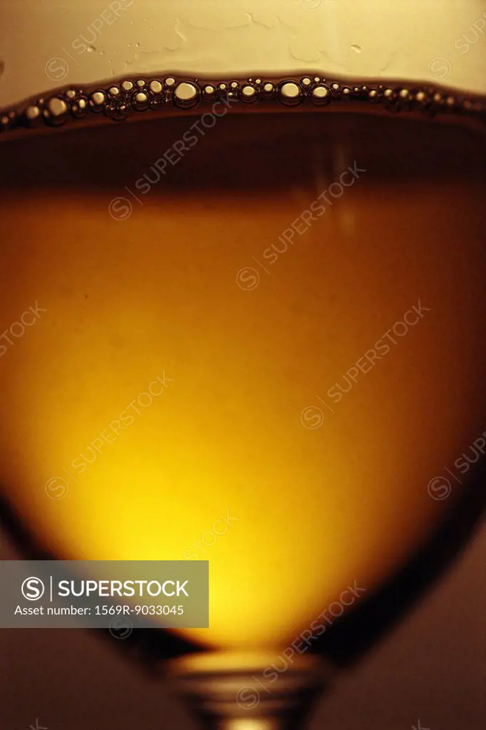 White wine in glass with bubbles, extreme close-up